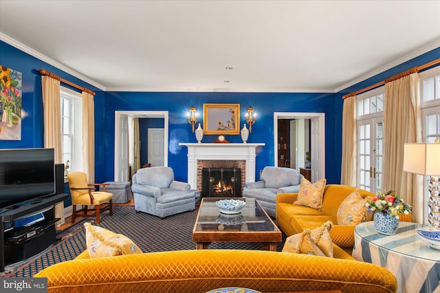 living room featuring plenty of natural light, crown molding, and a brick fireplace