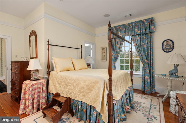 bedroom with hardwood / wood-style floors