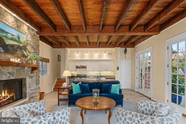 living room featuring beam ceiling, french doors, wooden ceiling, a fireplace, and light tile patterned flooring