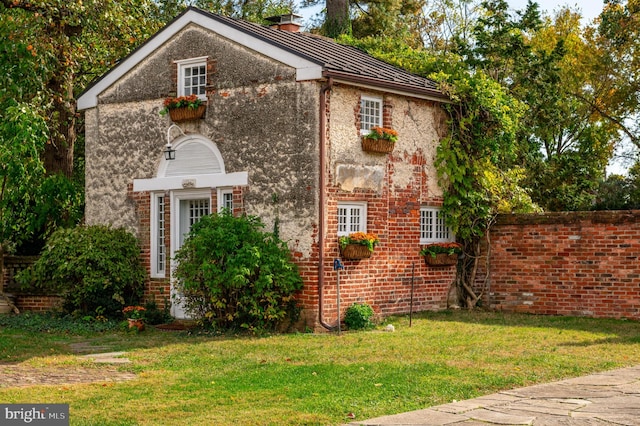 view of home's exterior featuring a yard