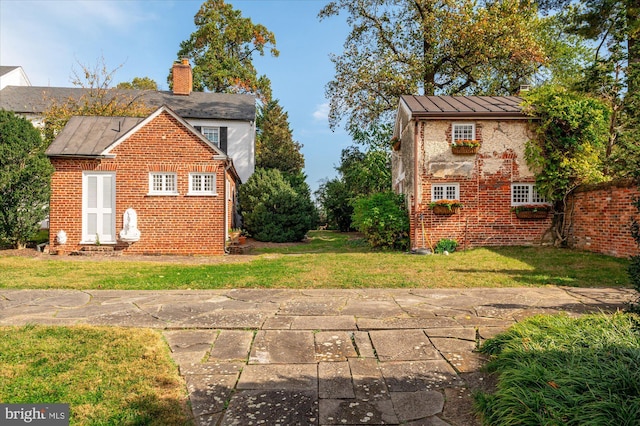 view of side of property with a yard