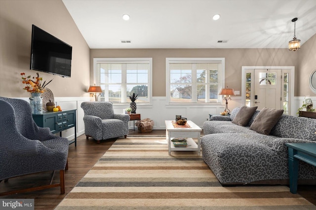 living room featuring dark wood-type flooring and vaulted ceiling