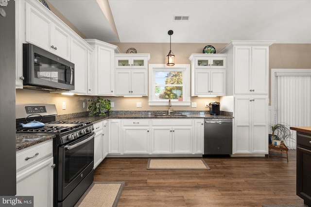 kitchen featuring hanging light fixtures, stainless steel appliances, sink, white cabinetry, and dark hardwood / wood-style flooring