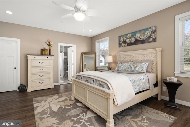 bedroom featuring multiple windows, dark hardwood / wood-style floors, and ceiling fan