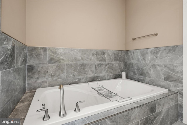 bathroom featuring tiled tub