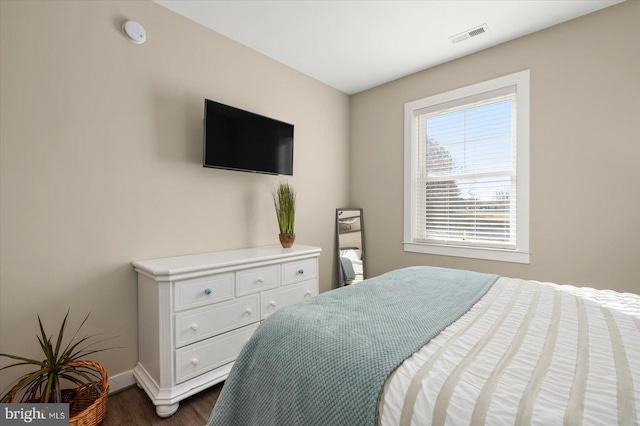 bedroom with dark hardwood / wood-style flooring