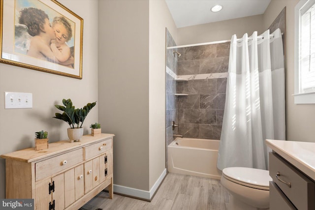 full bathroom featuring vanity, toilet, hardwood / wood-style flooring, and shower / bathtub combination with curtain