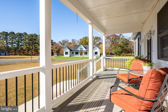 deck featuring a yard and a porch