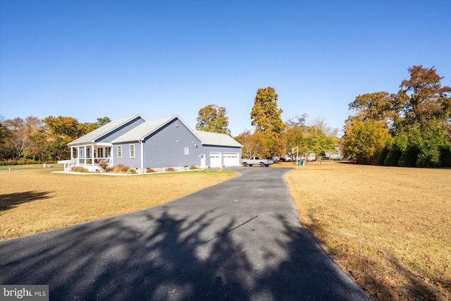 view of side of property with a lawn and a garage