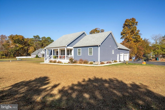 back of property featuring a yard and a sunroom