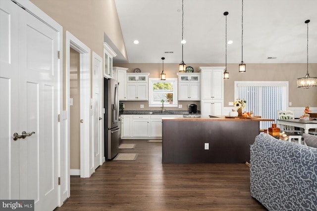 kitchen featuring white cabinetry, stainless steel refrigerator with ice dispenser, decorative light fixtures, and dark hardwood / wood-style floors