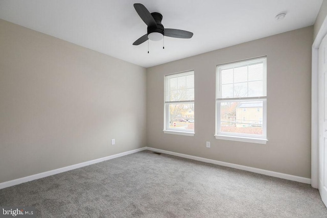 spare room with ceiling fan and carpet floors