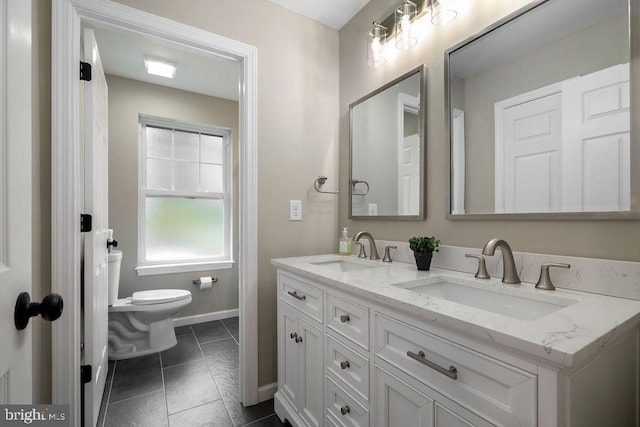 bathroom with tile patterned floors, vanity, and toilet