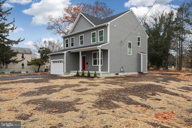 view of property featuring covered porch and a garage