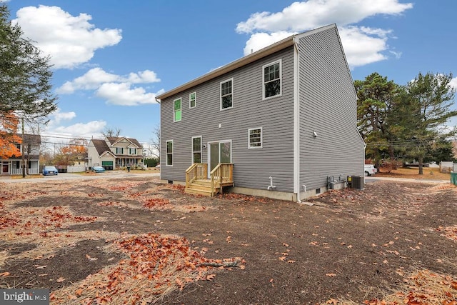 rear view of property with cooling unit