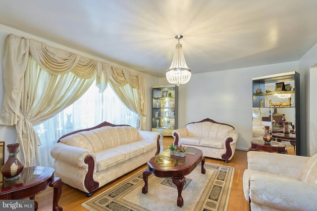 living room featuring wood-type flooring and an inviting chandelier