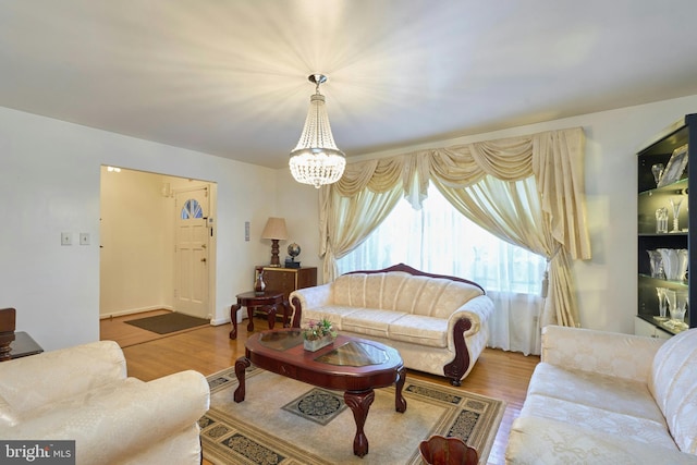 living room featuring hardwood / wood-style floors and an inviting chandelier