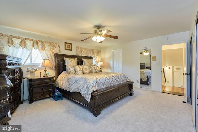 bedroom featuring ceiling fan, light colored carpet, and a closet