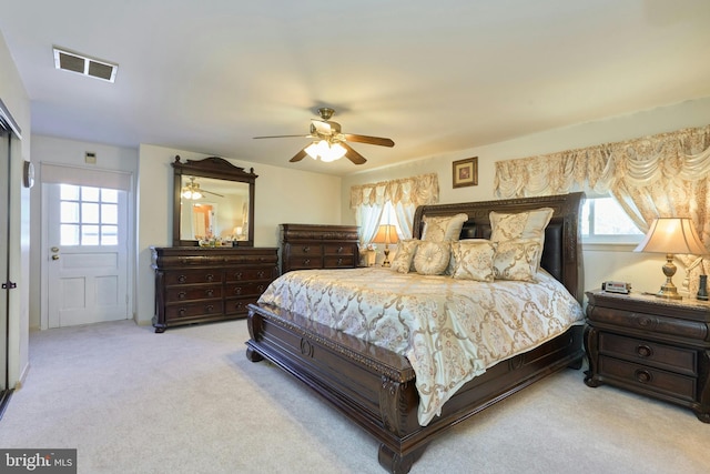 carpeted bedroom with multiple windows and ceiling fan