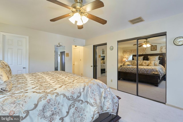 carpeted bedroom with ceiling fan and multiple closets