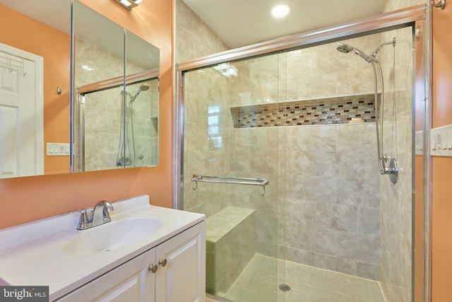 bathroom featuring vanity and a shower with door