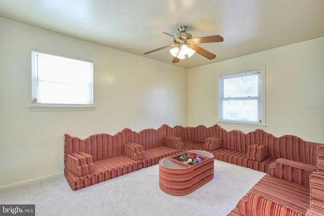 carpeted living room featuring ceiling fan