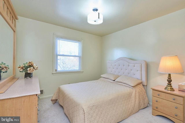 bedroom with light colored carpet