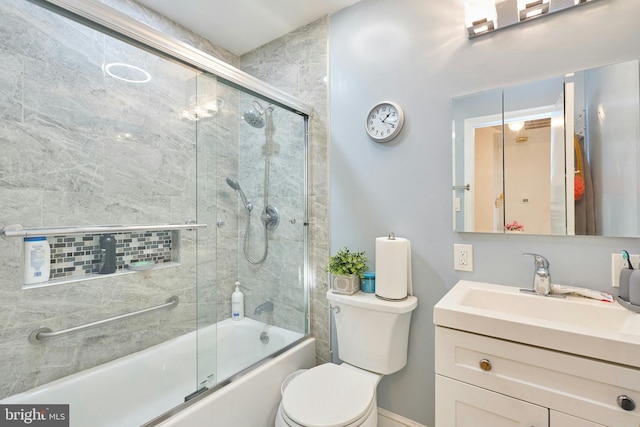 full bathroom featuring vanity, enclosed tub / shower combo, and toilet