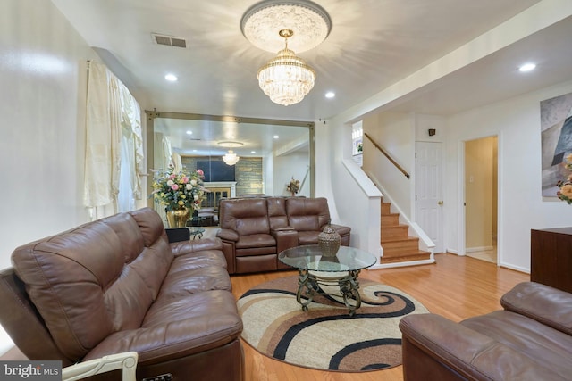 living room featuring light hardwood / wood-style flooring and a chandelier