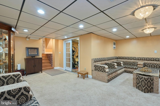 carpeted living room featuring a chandelier