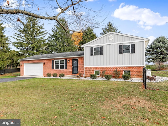 split level home featuring a garage and a front lawn