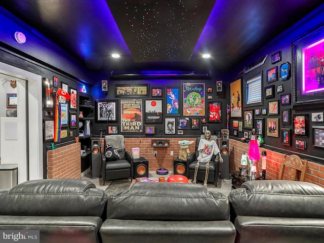 home theater room featuring brick wall