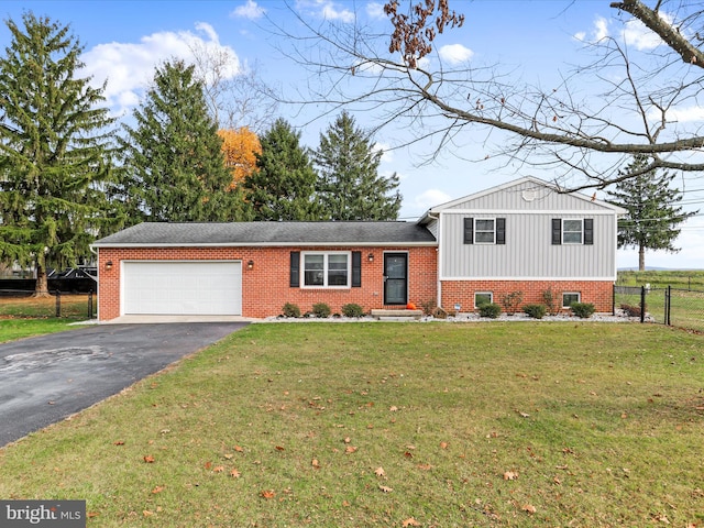 tri-level home featuring a front lawn and a garage