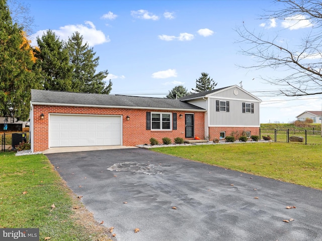 tri-level home featuring a front yard and a garage