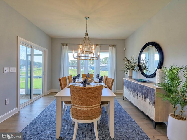 dining room with a notable chandelier and wood-type flooring