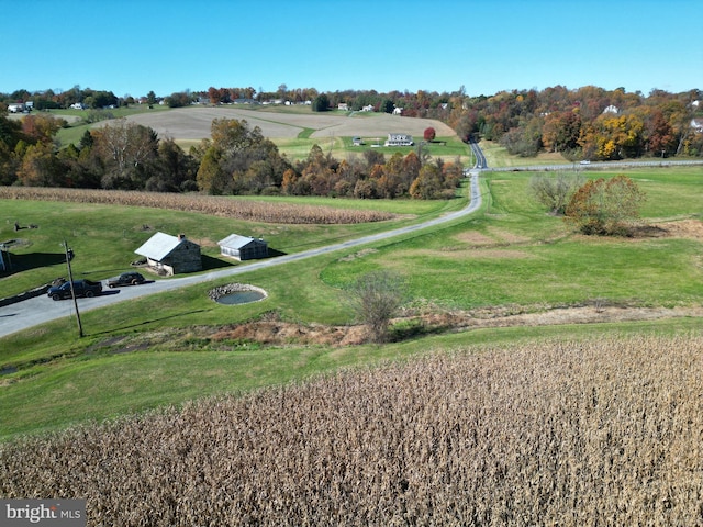 view of home's community featuring a rural view and a lawn