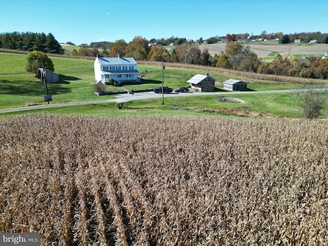 view of community with a yard and a rural view