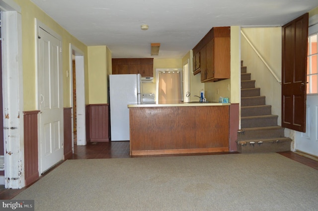 909 Ridge Rd, Westminster, MD 21157 - kitchen featuring freestanding refrigerator, under cabinet range hood, light countertops, dark colored carpet, and a peninsula