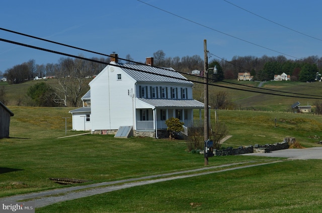 909 Ridge Rd, Westminster, MD 21157 - view of front of home with a porch, a front yard, a standing seam roof, metal roof, and a chimney