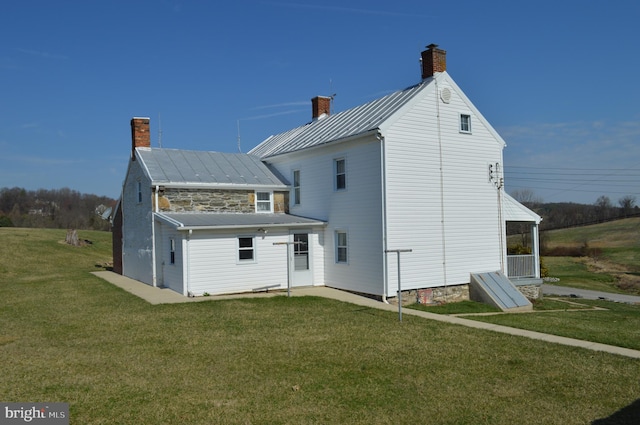 909 Ridge Rd, Westminster, MD 21157 - rear view of house with metal roof, a standing seam roof, a yard, and a chimney