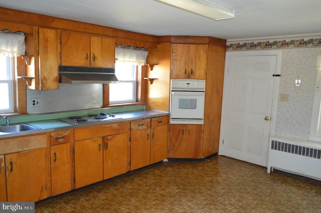 909 Ridge Rd, Westminster, MD 21157 - kitchen with white oven, under cabinet range hood, radiator heating unit, stainless steel electric stovetop, and a sink