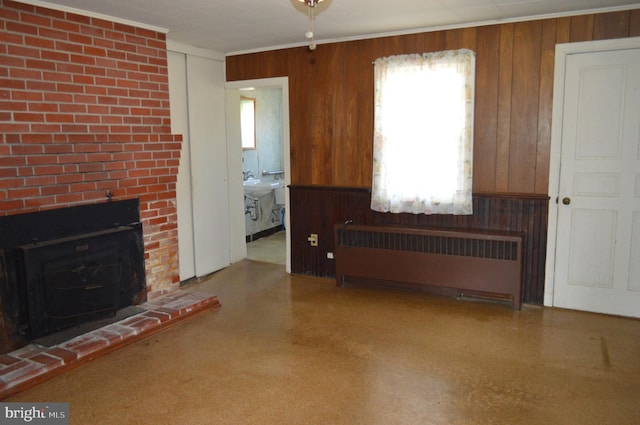 909 Ridge Rd, Westminster, MD 21157 - living room featuring radiator heating unit, a healthy amount of sunlight, wood walls, and a wood stove