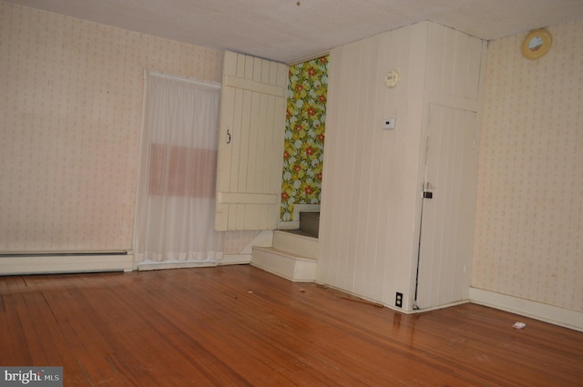 909 Ridge Rd, Westminster, MD 21157 - unfurnished room featuring baseboard heating, wallpapered walls, and wood finished floors