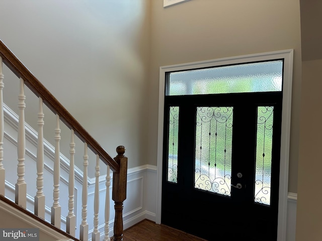 entryway featuring dark wood-type flooring and a wealth of natural light