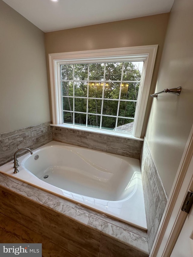 bathroom with tiled tub