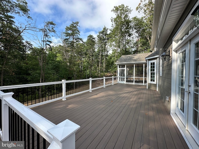 wooden deck with a sunroom