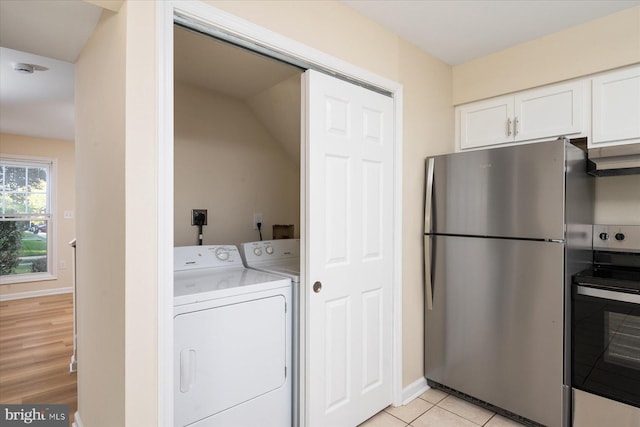 washroom featuring light hardwood / wood-style floors and washer and dryer