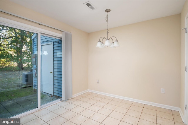 unfurnished room with light tile patterned flooring and an inviting chandelier