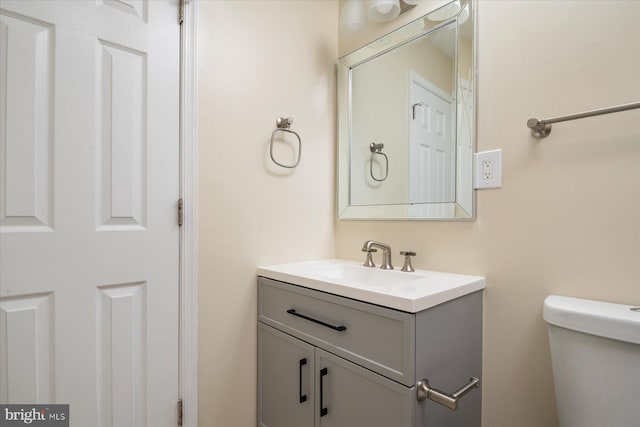 bathroom featuring toilet and vanity