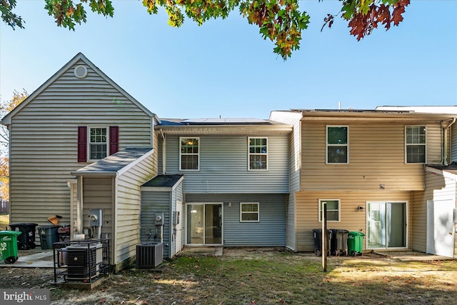 back of property featuring central AC